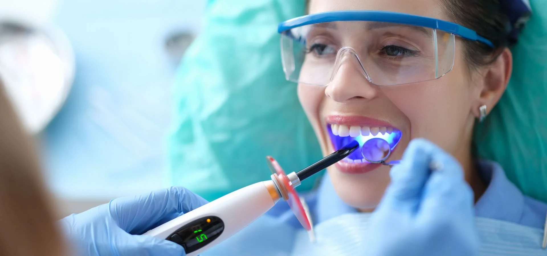 Dental treatment using a curing light