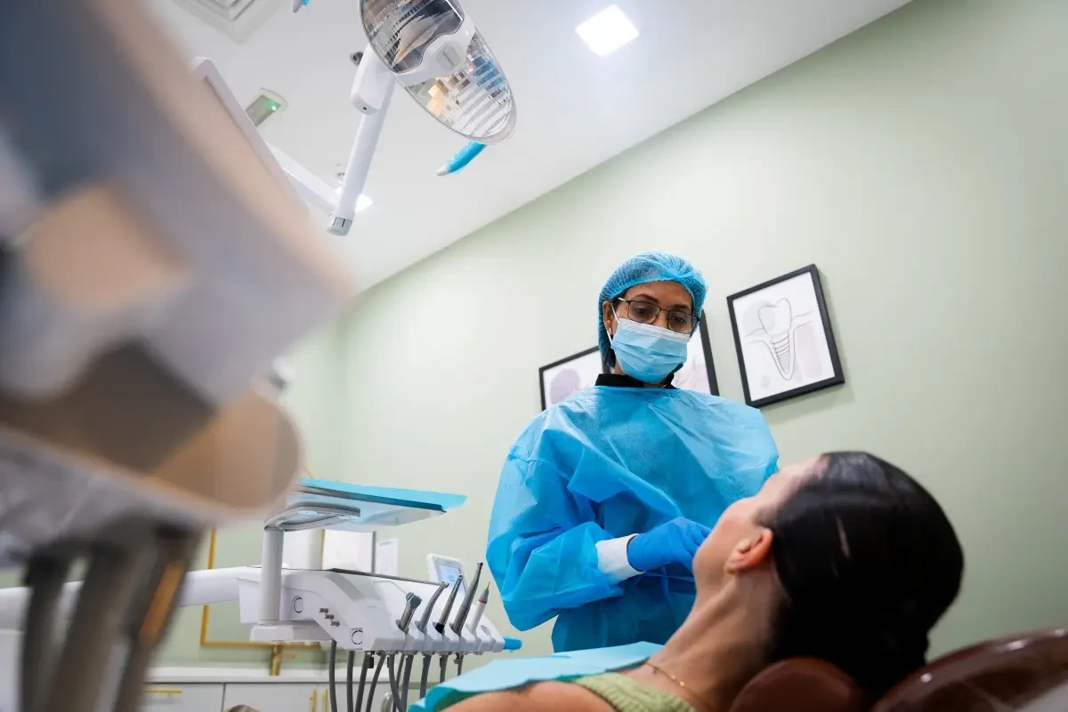 A dentist discussing care with a patient at Legacy Care