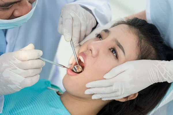 A dentist examining a patient using dental instruments